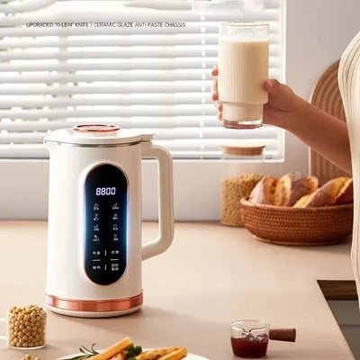 Smart soy milk maker on kitchen counter with digital display, glass of fresh soy milk
